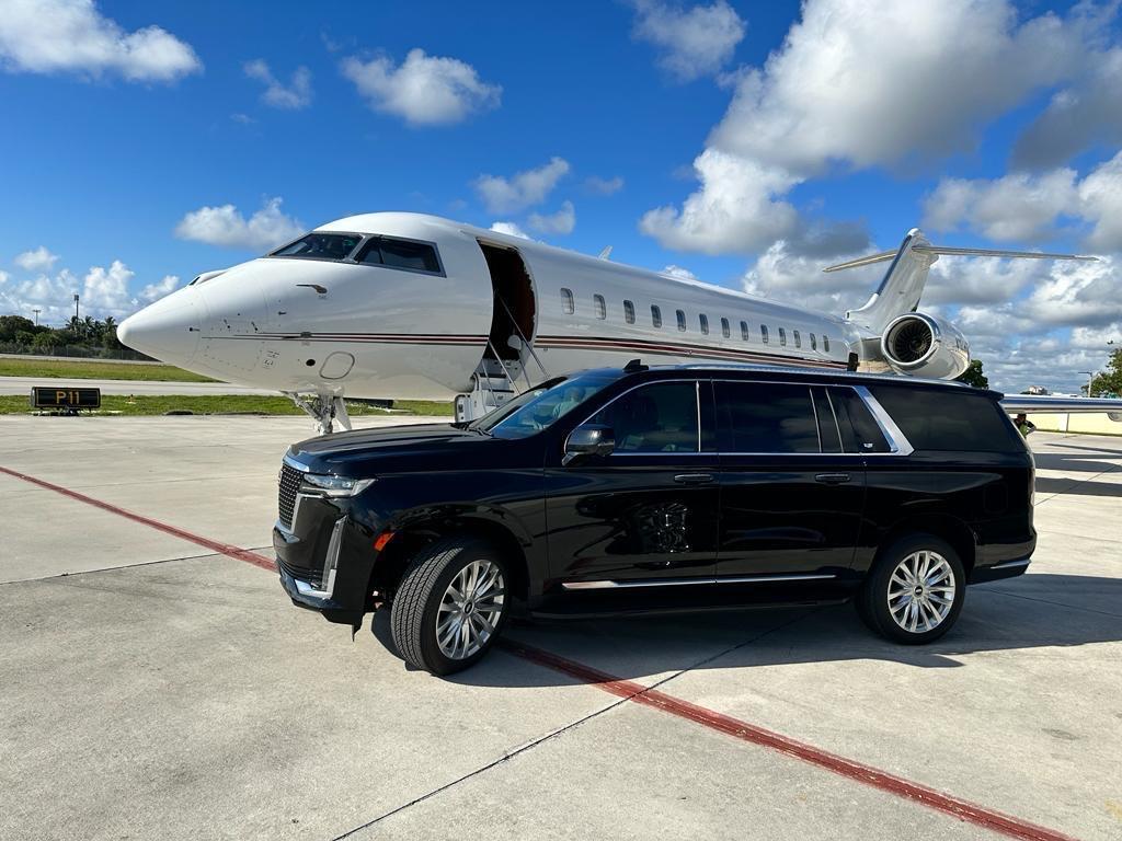 Businessman holding a mobile phone and a laptop in a limo